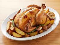 Golden Roasted Whole Chicken With Potatoes on White Platter.jpeg